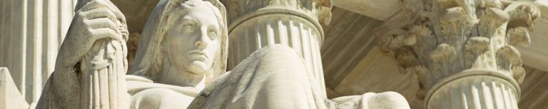 Contemplation of Justice statue on the steps of the US Supreme Court building