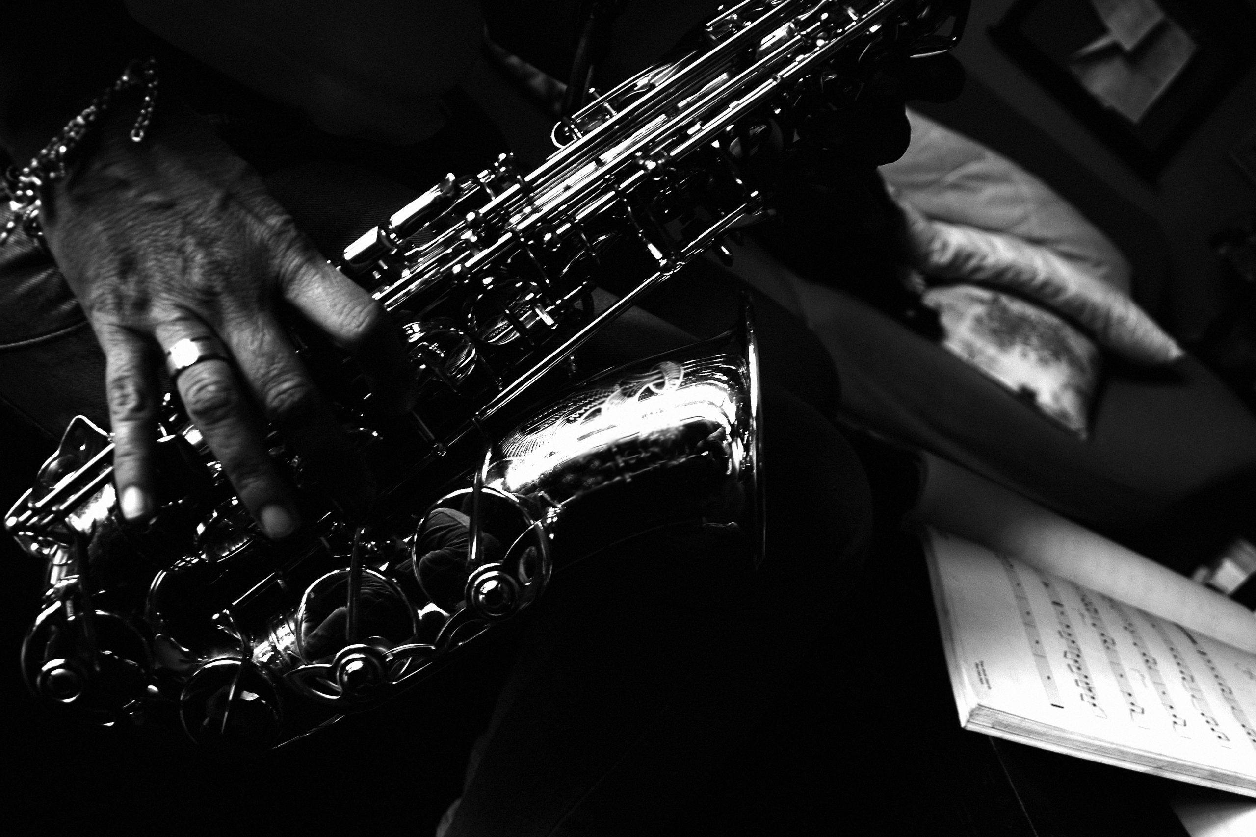 close up of man playing a saxophone