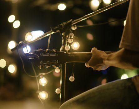 Guitarist singing into microphone