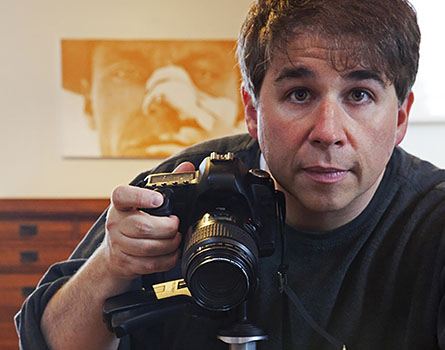 Photographer Christoper Boffoli holding a camera