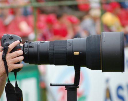 Professional Camera man taking a picture of a sporting event