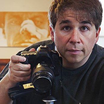 Photographer Christoper Boffoli holding a camera